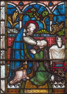 LONDON, GREAT BRITAIN - SEPTEMBER 19, 2017: The Ananias restoring sight to Saul  on the stained glass in St Mary Abbot's church on Kensington High Street. clipart