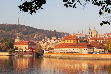 Prague - St. Nicholas church on Mala Strana and Strahov monastery in the background in morning.