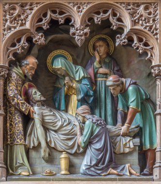 MECHELEN, BELGIUM - JUNE 14, 2014: Carved statues of scene the Burial of Jesus on new gothic side altar of church Our Lady across de Dyle. clipart