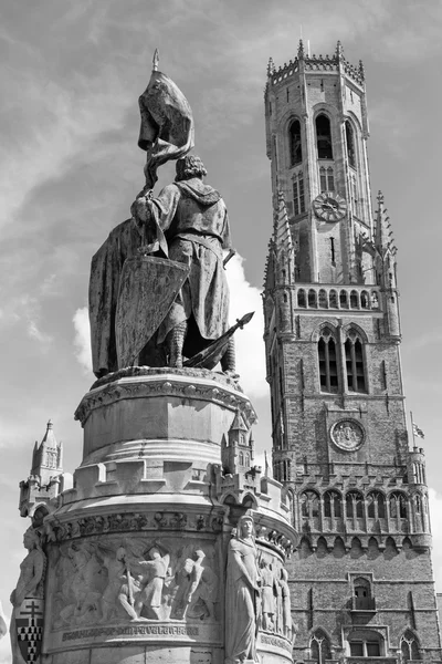 Брюгге - The Belfort van Brugge and memorial of Jan Breydel and Peter De Coninck on the Grote Markt square — стоковое фото