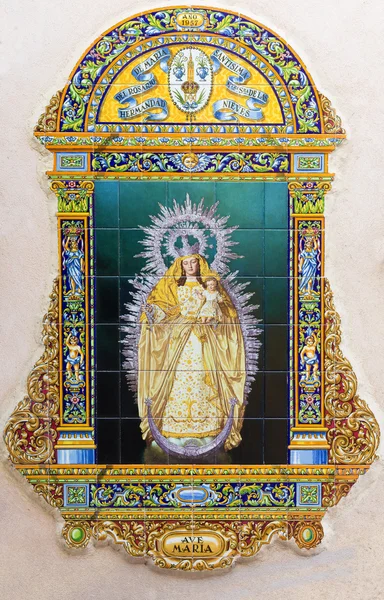 SEVILLE, SPAIN - OCTOBER 29, 2014: The ceramic tiled Madonna by A. Morilla from 20. cent. in manufacture Ceramica Santa Ana de Triana on the fadade of church Iglesia de Santa Maria de las Nieves. — Stock Photo, Image