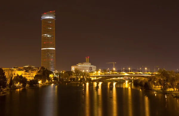 Sevilla, Spanien - 29. Oktober 2014: Ausblick auf den Fluss Guadalquivir und den modernen Cajasol Torre bei Nacht. — Stockfoto