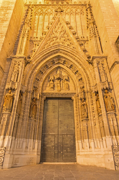 SEVILLE, SPAIN - OCTOBER 28, 2014: The portal Puerta de Bautismo from 15. cent by N. Martinez and J. Norman on the Cathedral de Santa Maria de la Sede.