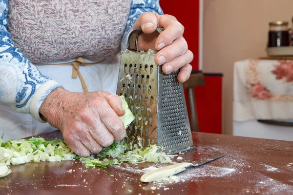 Hands of grandmother at cooking — Stock Photo, Image