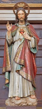 BANSKA STIAVNICA, SLOVAKIA - FEBRUARY 5, 2015: The carved and polychrome statue of heart of Jesus Christ in parish church by unknown artist of 19. cent. clipart