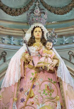 CORDOBA, SPAIN - MAY 26, 2015: The traditional vested statue of Madonna in Church Eremita de Nuestra Senora del Socorro on main altar designed by Alfons Gomes Caballero from 17. cent.