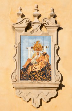 CORDOBA, SPAIN - MAY 26, 2015: The ceramic tiled Pieta on the facade of church Iglesia de San Augustin by artist Mensaque Rodriguez from 20. cent.