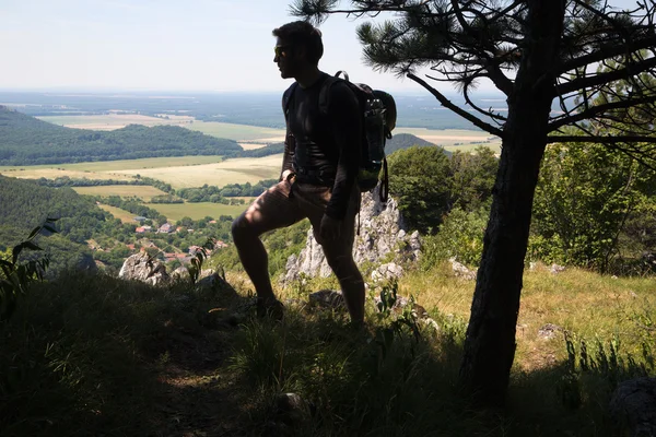 Sylwetka człowieka na szczycie wzgórza w trekkingu — Zdjęcie stockowe