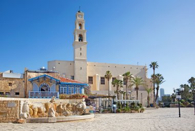 TEL AVIV, ISRAEL - MARCH 2, 2015: The st. Peters church in old Jaffa and the   modern Zodiac Fountain on Kedumim Square with the statues of astrological signs by Varda Ghivoly and Ilan Gelber in 2011.