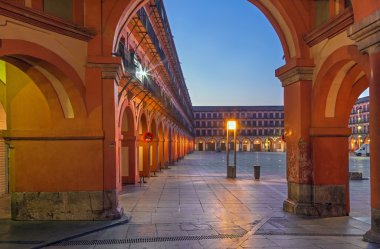 CORDOBA, SPAIN - MAY 27, 2015: The porticoes of Plaza de la Corredera square at dusk.