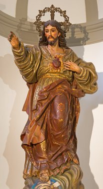 MALAGA, SPAIN - MAY 31, 2015: The carved polychrome statue of The Heard of Jesus in Iglesia del Santiago Apostol church by unknown artist of 18. cent.