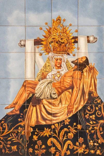 CORDOBA, SPAIN - MAY 26, 2015: The ceramic tiled Pieta on the facade of church Iglesia de San Augustin by artist Mensaque Rodriguez from 20. cent. — Stockfoto