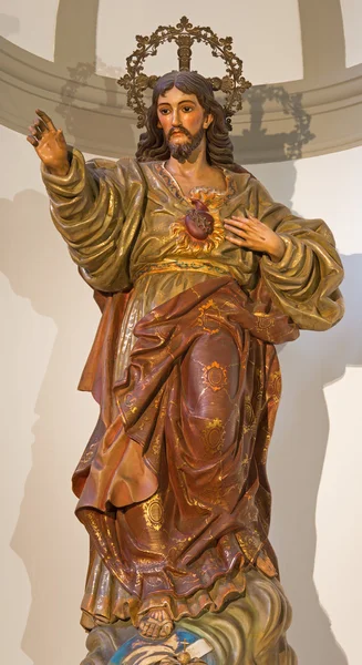 MALAGA, SPAIN - MAY 31, 2015: The carved polychrome statue of The Heard of Jesus in Iglesia del Santiago Apostol church by unknown artist of 18. cent. — Stock Photo, Image