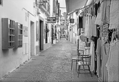 CORDOBA, SPAIN - MAY 26, 2015: The street Velasques Bosco with the little shops and bars.