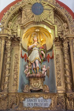 CORDOBA, SPAIN - MAY 26, 2015: The carved and polychrome statue of archangel Raphael in Church Eremita de Nuestra Senora del Socorro on side altar by Alfonso Gomes de Sandoval from 17. cent.