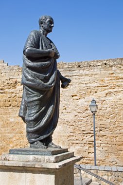 CORDOBA, SPAIN - MAY 25, 2015: The statue of philosopher Lucius Annaeus Seneca the Younger by Amadeo Ruiz Olmos (1913 - 1993) and medieval gate Puerta del Almodovar.