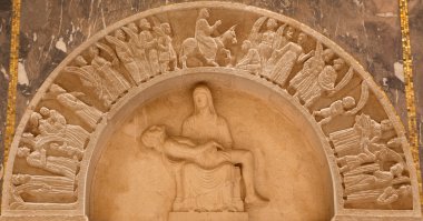 JERUSALEM, ISRAEL - MARCH 3, 2015: The pieta and Entry of Jesus to Jerusalem (Palm sunday) relief in Evangelical Lutheran Church of Ascension by unknown artist of 20. cent.
