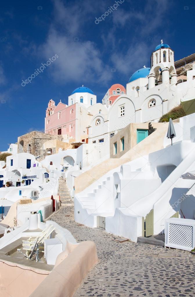 Santorini - The look to typically blue churches cupolas in Oia with the white house stairs.
