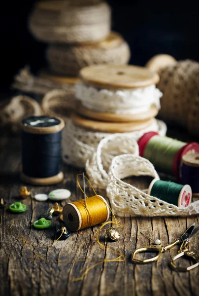 Tools for needlework, thread for sewing, scissors, buttons and laces