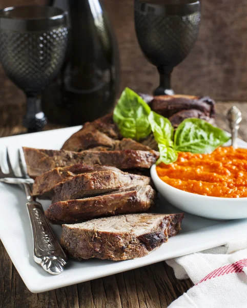 Baked leg of Lamb with red pepper sauce — Stock Photo, Image