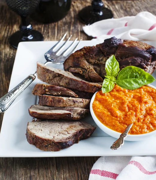 Baked leg of Lamb with red pepper sauce — Stock Photo, Image