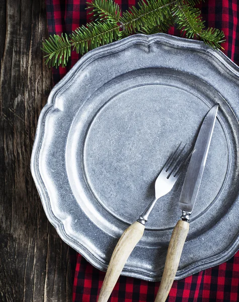 Vintage silverware on rustic metal plate for Christmas Dinner