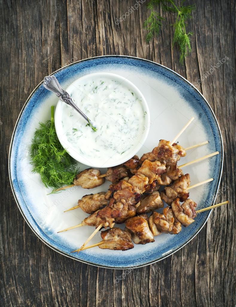 Barbecue chicken skewers with yogurt sauce. Stock Photo by ©Anjela30