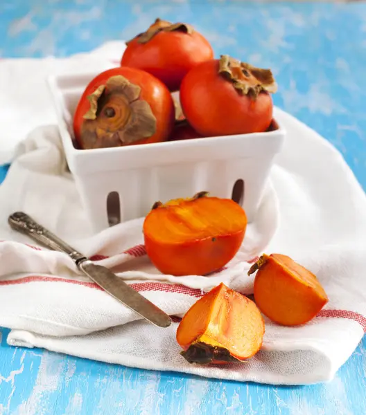 Fresh ripe persimmon on a wooden table — Stock Photo, Image