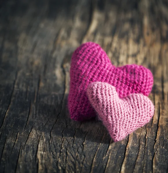 Dois corações rosa de crochê no fundo de madeira — Fotografia de Stock