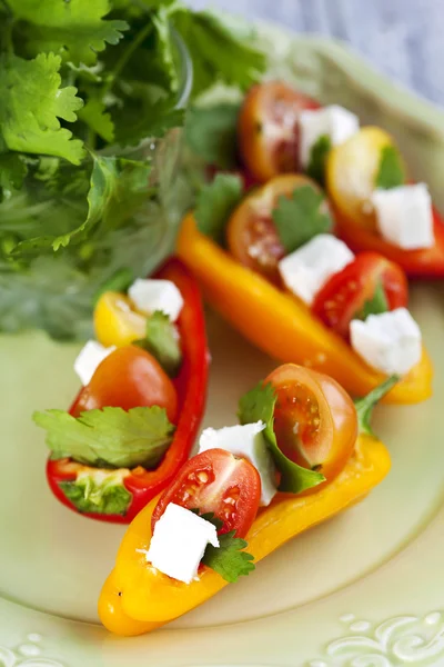 Mini pepper stuffed with mini tomato and feta cheese — Stock Photo, Image
