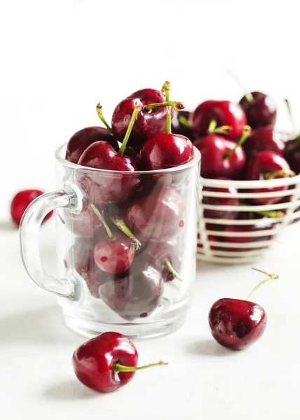 Fresh sweet cherry in glass cup — Stock Photo, Image