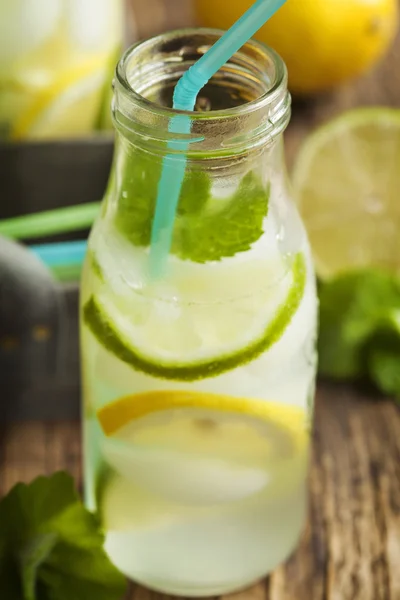 Close up Lemonade in glass bottle with ice and mint — Stock Photo, Image