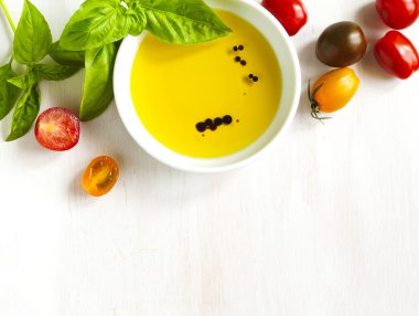 Fresh tomatoes, basil, olive oil with balsamic vinegar on wooden background