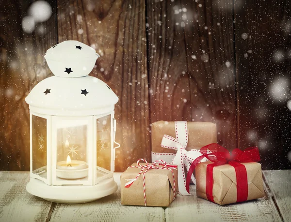 Christmas gifts and candle — Stock Photo, Image