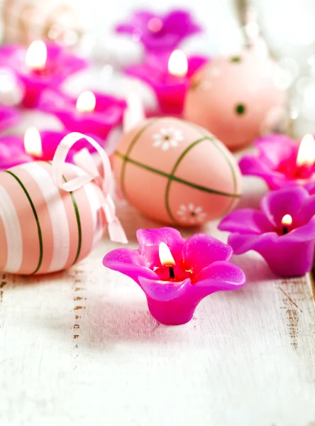 Candles and egg decorations on wooden background. — Stock Photo, Image