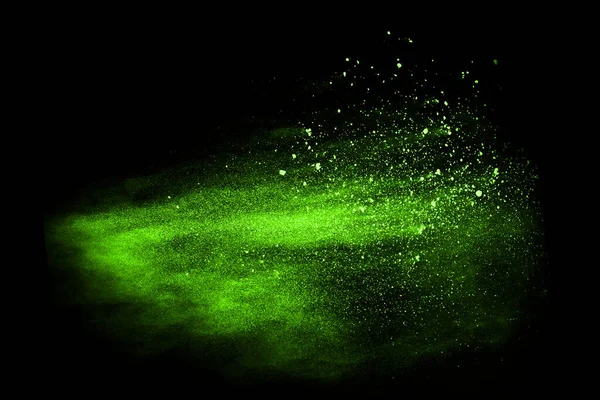 The movement of abstract dust explosion frozen green on black background. Stop the movement of powdered green on black background. Explosive powder green on black background.