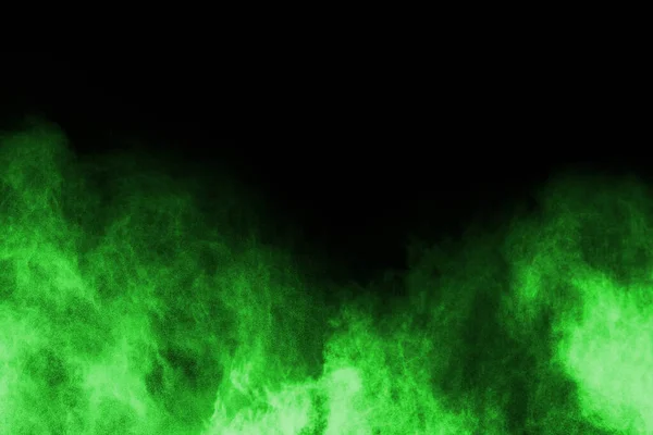 The movement of abstract dust explosion frozen green on black background. Stop the movement of powdered green on black background. Explosive powder green on black background.