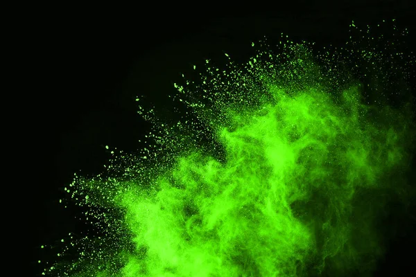 The movement of abstract dust explosion frozen green on black background. Stop the movement of powdered green on black background. Explosive powder green on black background.