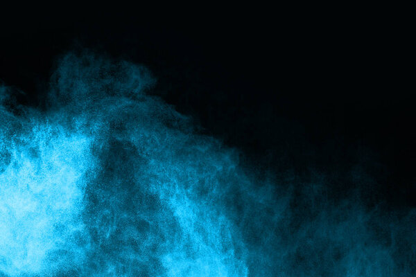 Abstract blue powder splatted background,Freeze motion of color powder exploding/throwing color powder,color glitter texture on black background.