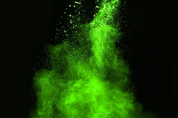 The movement of abstract dust explosion frozen green on black background. Stop the movement of powdered green on black background. Explosive powder green on black background.