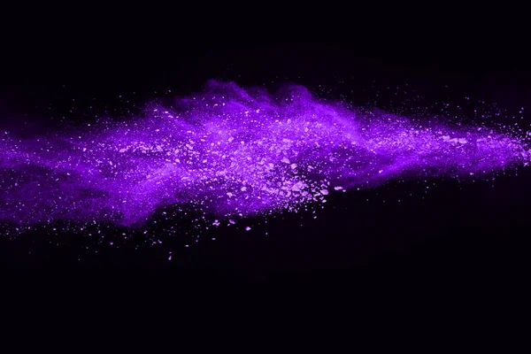 The movement of abstract dust explosion frozen purple on black background. Stop the movement of powdered purple on black background. Explosive powder purple on black background.