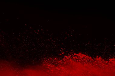Siyah arka planda soyut kırmızı toz patlaması. Siyah arka planda soyut kırmızı toz sıçramış. Patlayan kırmızı barutun hareketsiz hareketi.