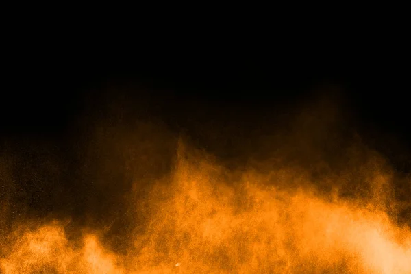 abstract orange powder splatted background,Freeze motion of color powder exploding/throwing color powder,color glitter texture on black background