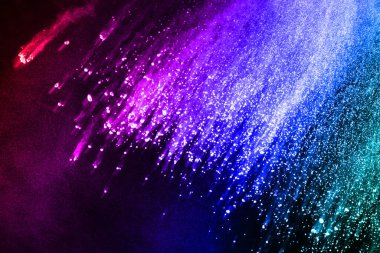 Siyah bir zemin üzerinde soyut renkli toz patlaması. Soyut toz püskürtülmüş arka plan, renk tozunun patlaması / renk tozunun dondurucu hareketi, çok renkli sim dokusu.