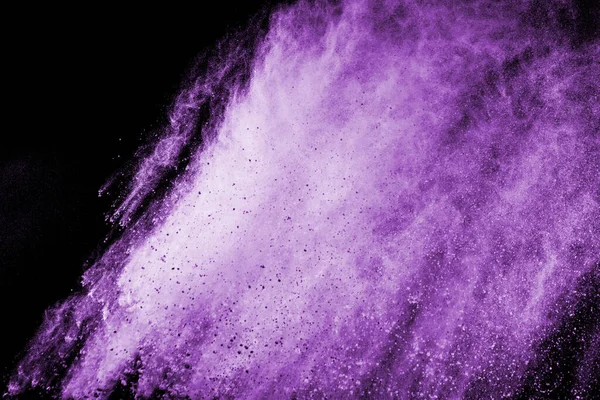 The movement of abstract dust explosion frozen purple on black background. Stop the movement of powdered purple on black background. Explosive powder purple on black background.