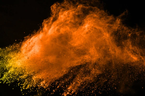 abstract orange powder splatted background,Freeze motion of color powder exploding/throwing color powder,color glitter texture on black background
