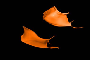 Turuncu boya sıçraması siyah arkaplanda izole edildi.