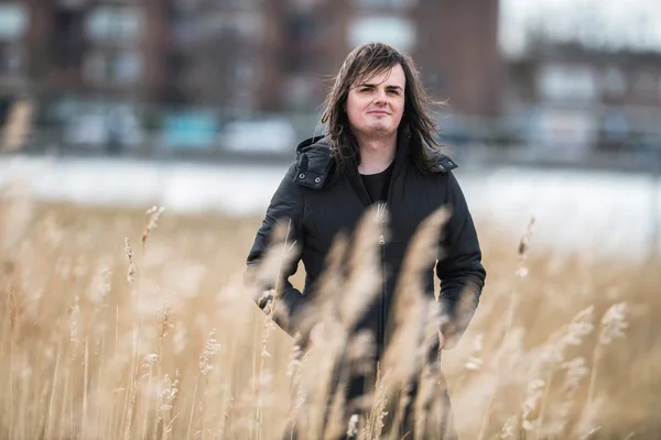 Androgynous man in field of reed — Stock Photo, Image