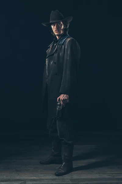 Menacing cowboy standing with revolver — Stock Photo, Image