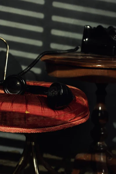 Vintage Black Telephone Wooden Table Receiver Red Chair Room Evening — Stock Photo, Image